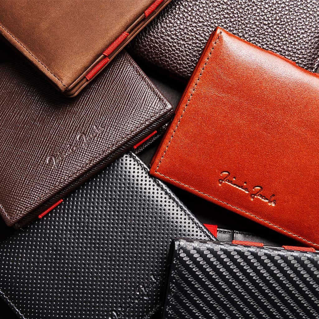Several high-quality leather wallets lying on top of each other